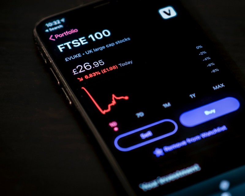 Mobile phone showing FTSE100 falling shares chart