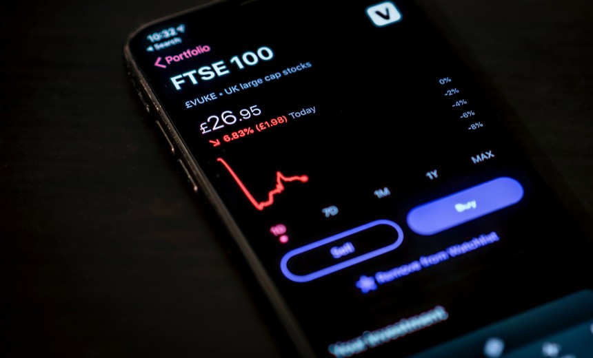 Mobile phone showing FTSE100 falling shares chart